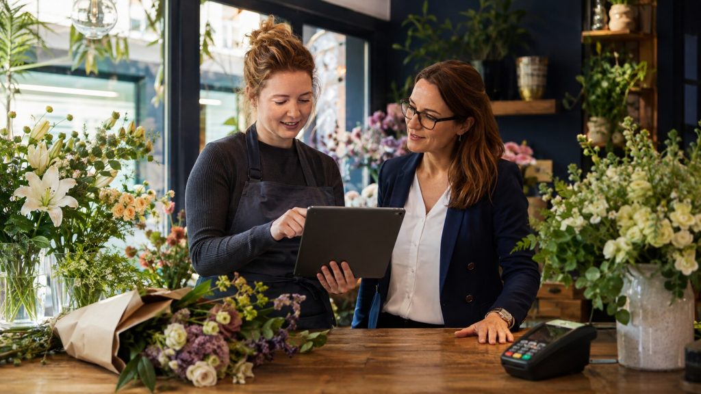 Independent florist reviewing VAT registration turnover with an accountant